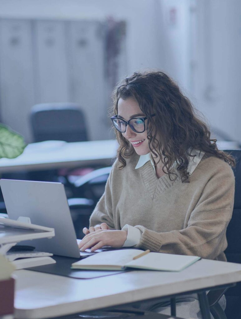 Office employee working on laptop — contact page